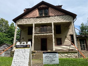 Historic home with white and red siding prepares for rennovations