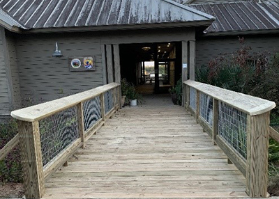 Brand new wooden boardwalk structure leading towards building entrance.