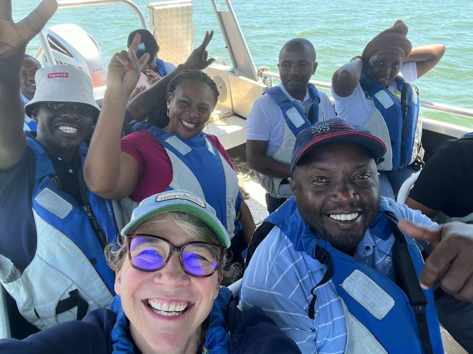 A group waves from a boat in southern Africa