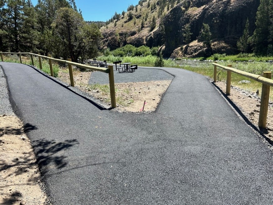 Paved path going to group site area or parking and follows the Crooked River allowing access.