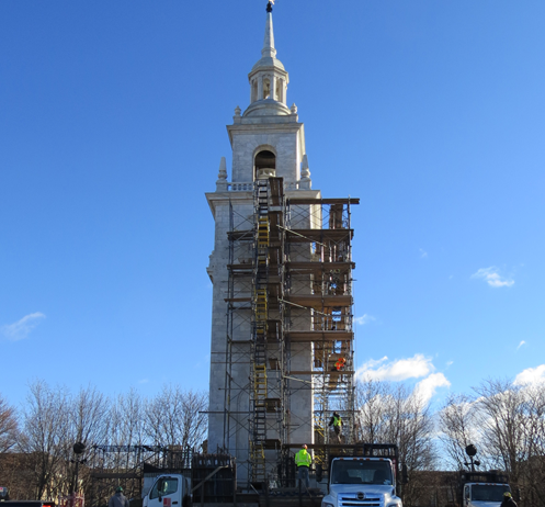 White historic tower with scaffolding on structure