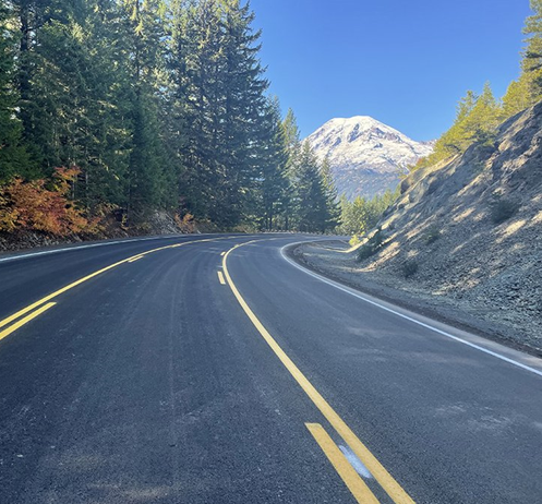 Paved road with white mountain peak in the background