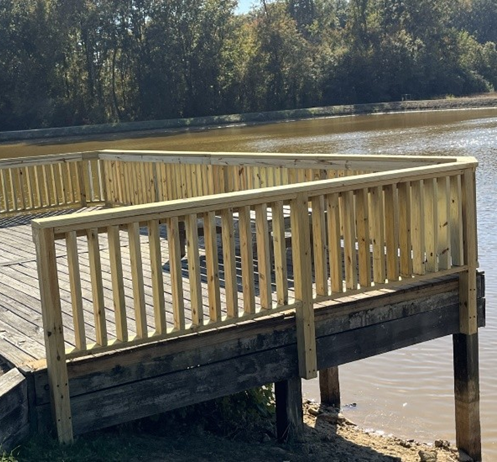 Tan, wooden deck with body of water in the background