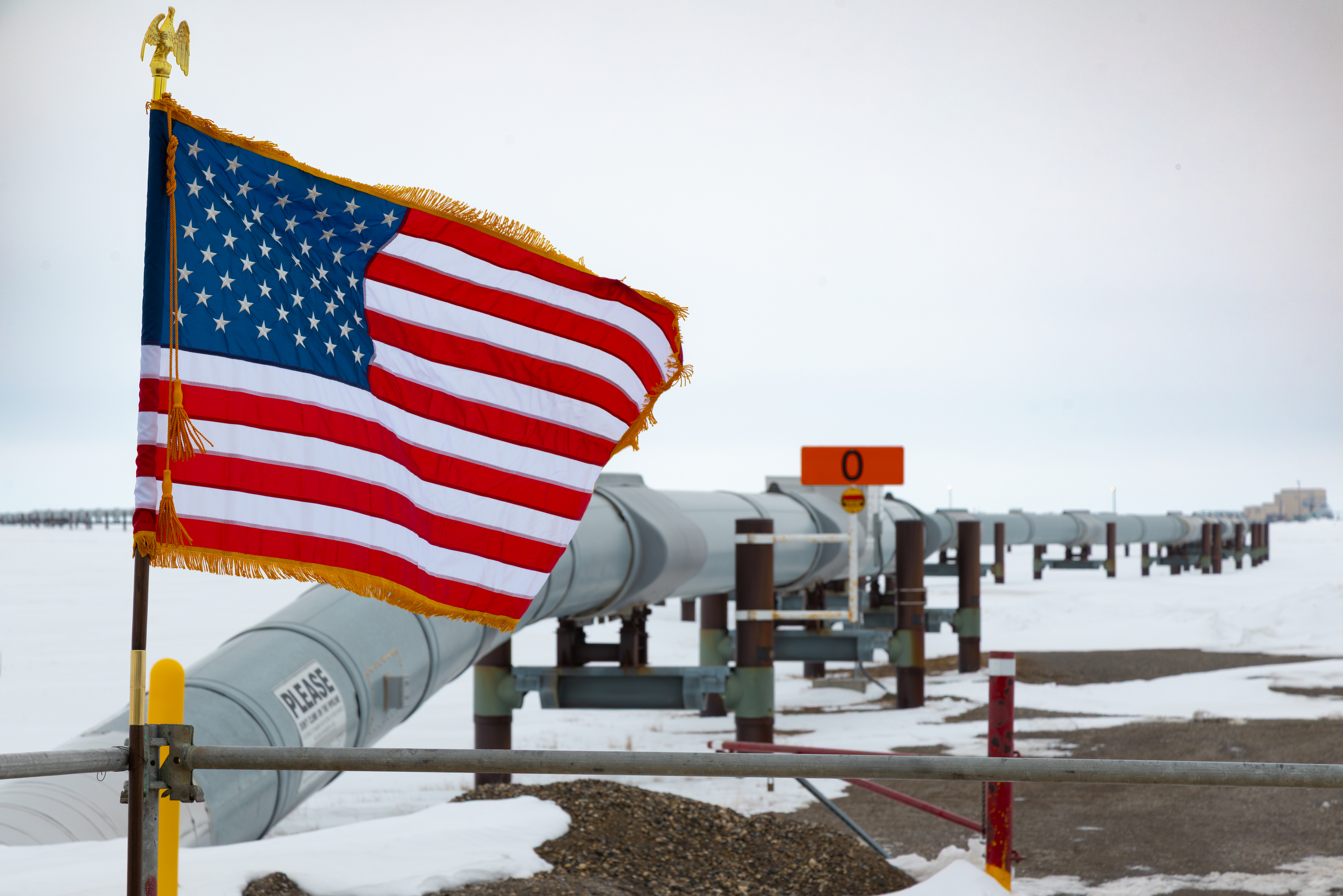 Alaska pipeline behind American flag