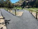 Paved path going to group site area or parking and follows the Crooked River allowing access.