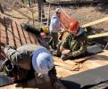 Maintenance Workers repair wooden roof