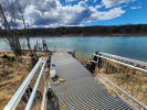 Newly restored boardwalk leads to bright blue body of water