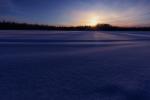 Sunrise over snowy lake at Kenai National Wildlife Refuge in Alaska.