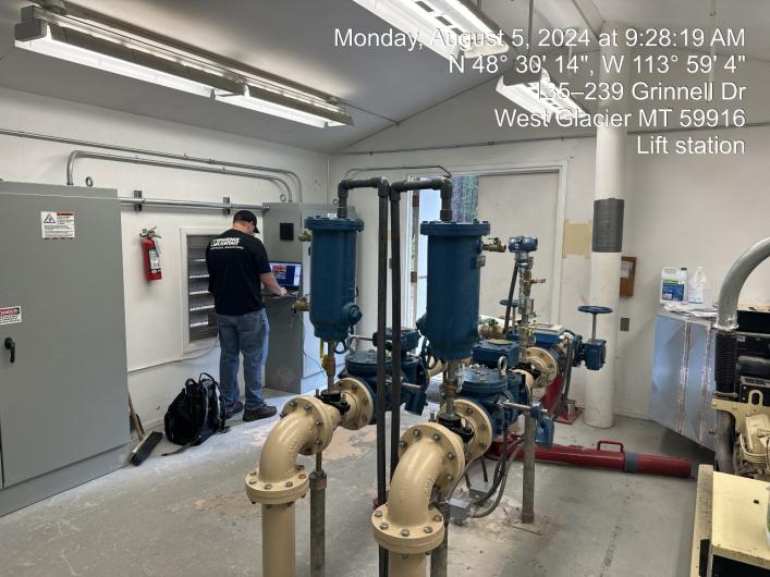 New wastewater system inside a white room with concrete floors.