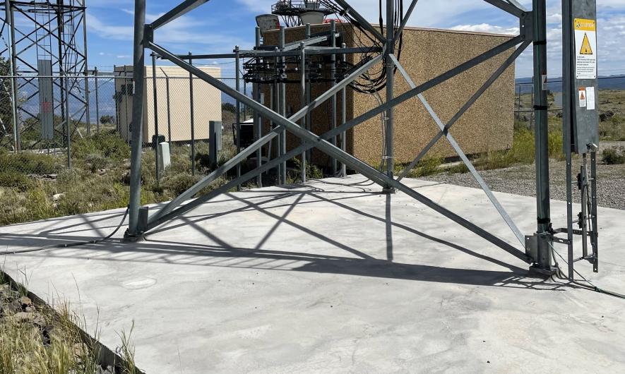Close up view of concrete base of radio tower.