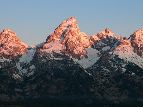 The sunrise morning light hits the mountain peaks.