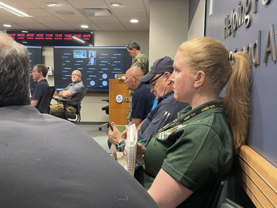 A group of people being briefed in a meeting room