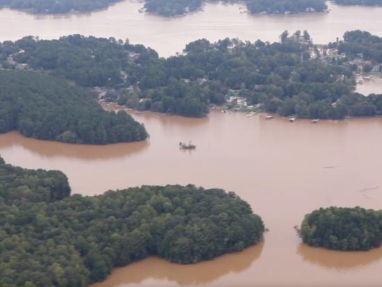 Floodwaters thread through a rural community