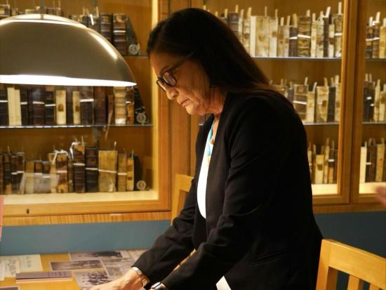 Secretary Haaland in library looking down at book.