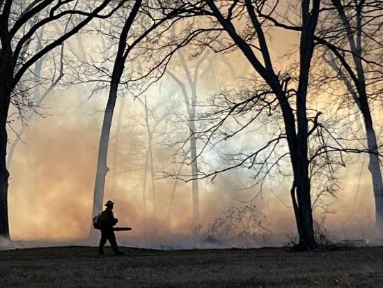 A wildland firefighter conducts prescribed burn work on Chickasaw Nation lands. Photo by Josh Williams