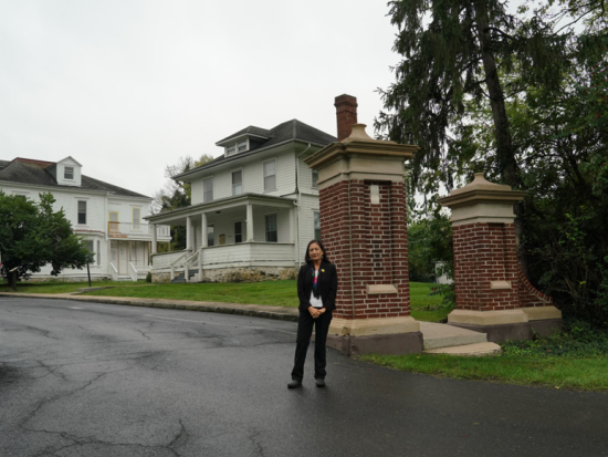 Secretary Haaland stands at the entrance of Carlisle Indian Boarding School