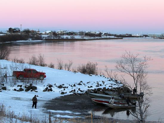 men getting boats ready on a snowy bank of Kuskokwim River