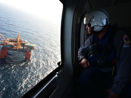 Helicopter aerial view of an offshore oil rig in Gulf of America