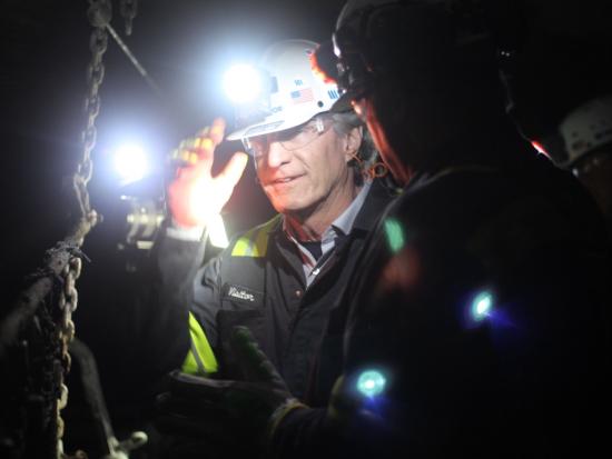 Secretary Burgum wearing hard hat and headlamp. 