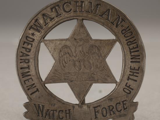 Pin-style badge with a six-pointed star, eagle, and the words, "Department of the Interior Watch Force Watchman"