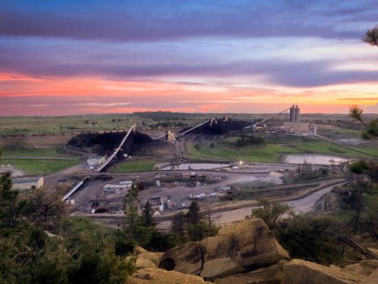 Purple and orange sunrise over mine surface facilities.