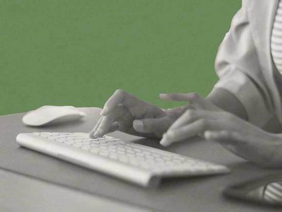 Person typing on keyboard