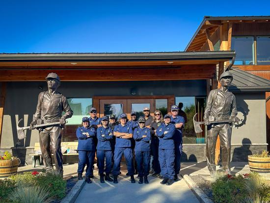 Behavioral Health Officers serving wildland fire personnel with the Interior and Agriculture departments stand at the entrance to the National Interagency Fire Center in Boise, Idaho.