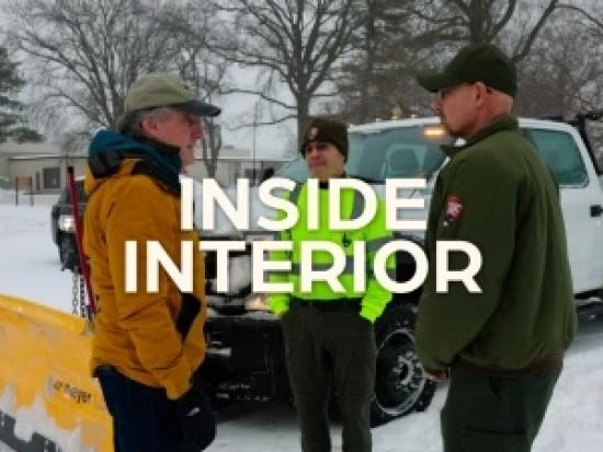 Secretary Burgum Speaks in Front of a snow plow
