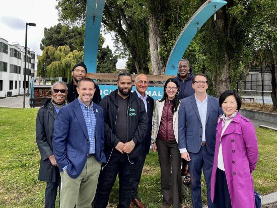 Assistant Secretary Estenoz smiling with a group of community leaders in San Francisco