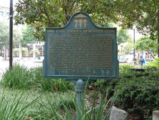 A metal historical marker in a park describes a 1960 civil rights event in Florida.