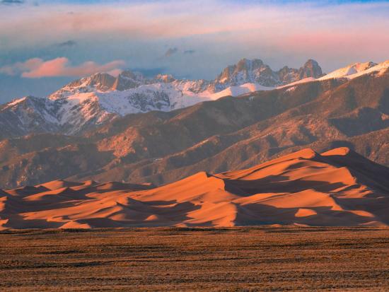 Star Dune and Crestone Peaks in Great Sand Dunes National Park and Preserve lit by the sunset