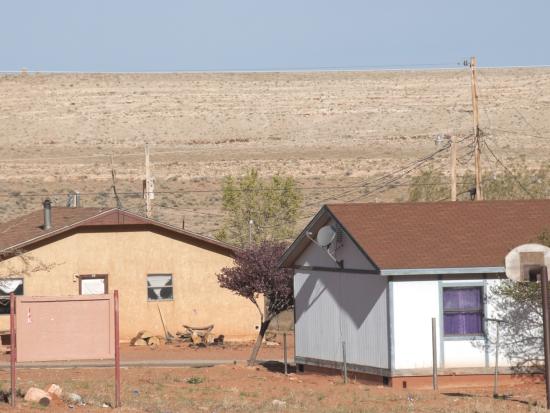 Two houses in desert landscape. 
