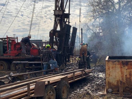 A view of laborers working to plug an orphaned oil and gas well