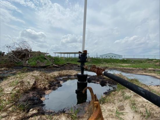 Abandoned well with large cloudy sky in backdrop