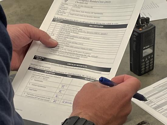 Wildland firefighter filling out form. 