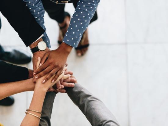 Hands huddle in a circle