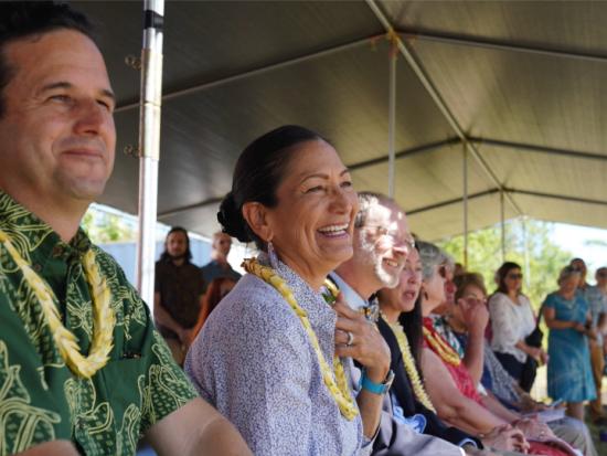 Secretary Haaland and Senator Brian Schatz watch a Native Hawaiian ceremony