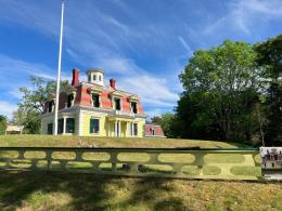 2.5 story, wood-frame structure with a mansard roof.