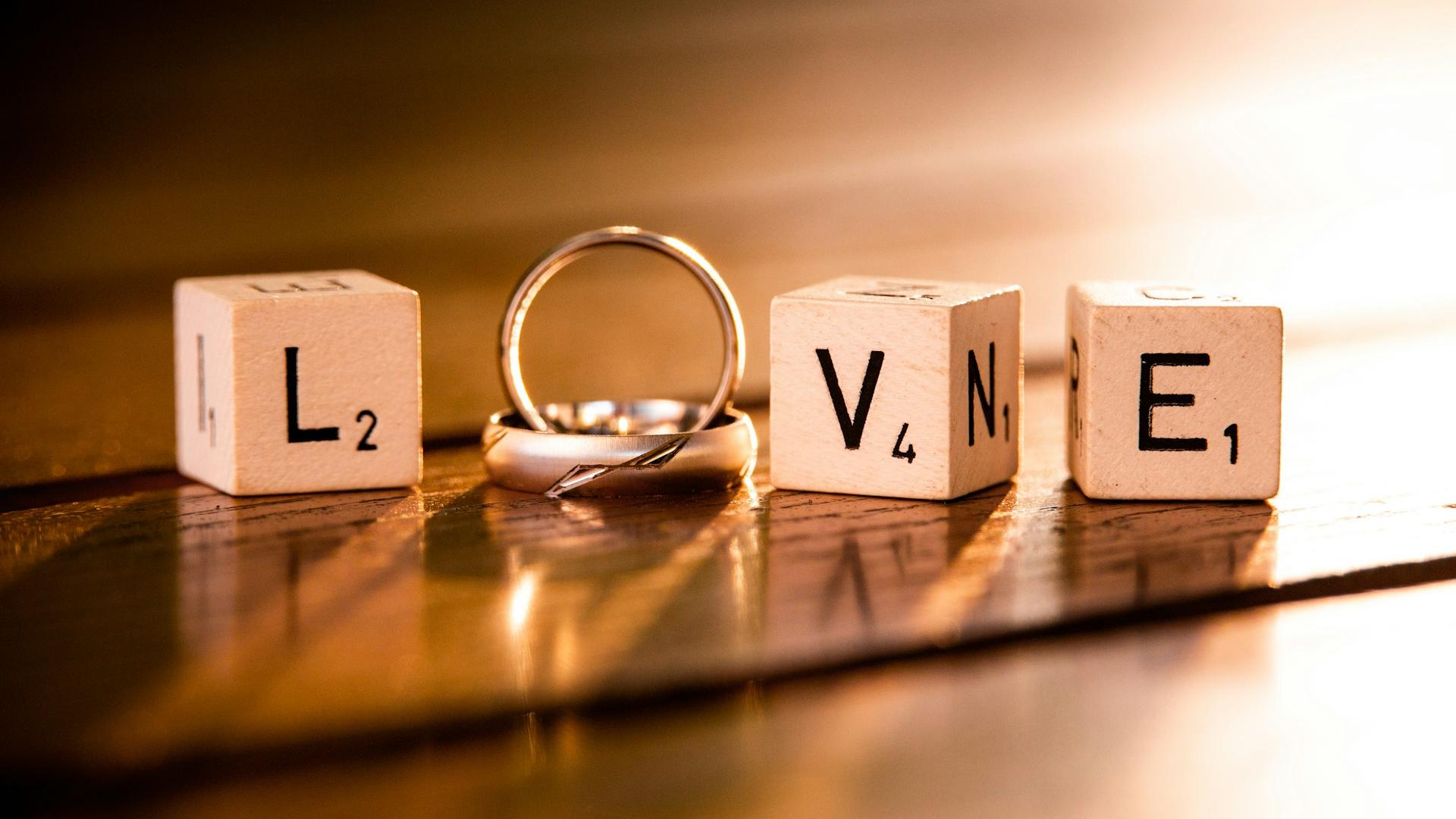 "Love" spelled with two wedding rings and three blocks